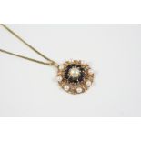 A SAPPHIRE AND CULTURED PEARL PENDANT the gold flower head is centred with a cultured  pearl