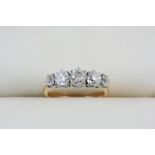 A DIAMOND FIVE STONE RING set with five graduated old brilliant-cut diamonds, in gold. Size N.