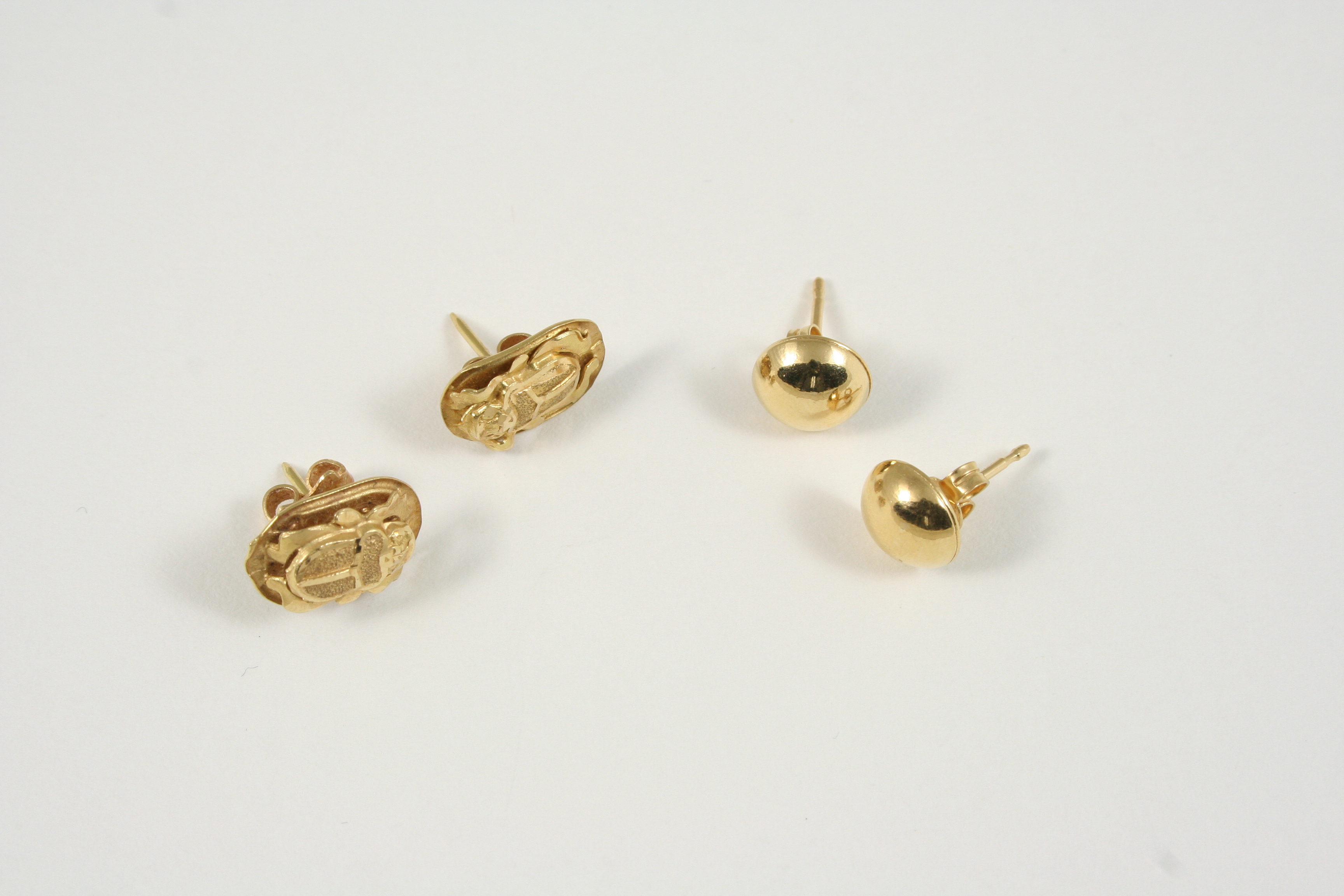 A PAIR OF GOLD SCARAB GOLD STUD EARRINGS 1.5cm., together with a pair of gold circular domed stud