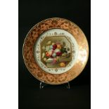 A DERBY PLATE c. 1825 painted with fruit in a basket on a plinth inside an apricot and gilt