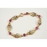A TOURMALINE AND GOLD BRACELET each of the six circular-cut pink tourmalines are separated by a