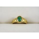 A GOLD RING set with an oval turquoise cabochon. Size Q.