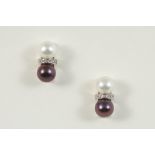 A PAIR OF DIAMOND AND CULTURED PEARL EARRINGS each set with a white and black cultured pearl