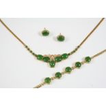 A NEPHRITE JADE AND GOLD NECKLACE formed with five oval jade cabochons, with small jade cabochons