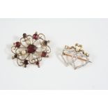 A GEORGIAN GARNET AND PEARL SET BROOCH the gold openwork brooch is centred with an oval-shaped