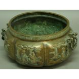 A CHINESE BRASS JARDINIERE, of lobed two handled form, decorated in relief with various scenes,