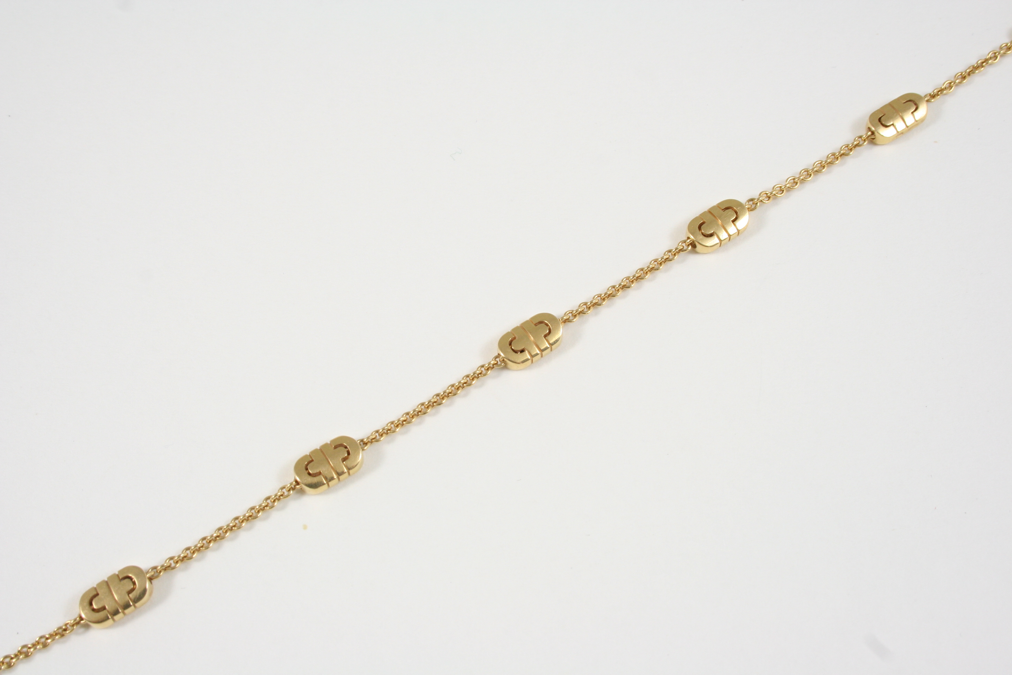 AN 18CT. GOLD BRACELET BY BVLGARI formed with oval geometric links to a gold chain, signed to the