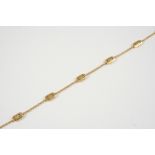 AN 18CT. GOLD BRACELET BY BVLGARI formed with oval geometric links to a gold chain, signed to the