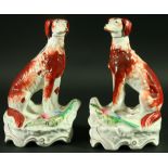 A PAIR OF STAFFORDSHIRE HOUNDS  late 19th Century, seated with games birds at their feet, 23cm