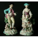 A PAIR OF DERBY SHEPHERD FIGURES late 18th Century on scrolling bases, patch marks. Height 21cm. (