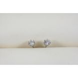 A PAIR OF DIAMOND STUD EARRINGS each set with a brilliant-cut diamond, in 18ct. white gold.