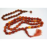 A SINGLE ROW AMBER BEAD NECKLACE 90cm. long, 99 grams, and an amber bead bracelet, 34 grams.