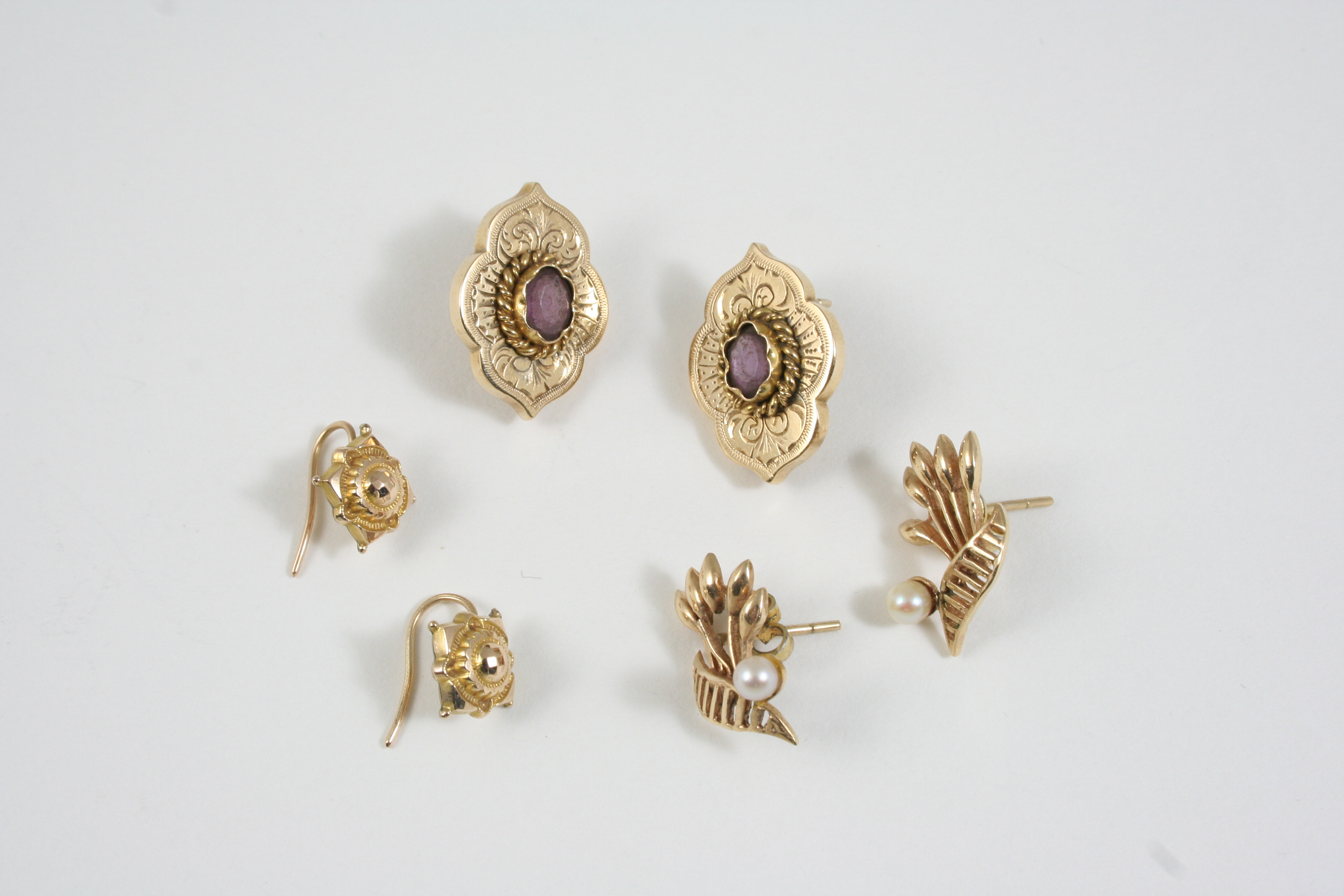 A PAIR OF AMETHYST AND GOLD EARRINGS each set with an oval-shaped amethyst, together with two