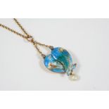 AN ENAMEL AND PEARL WINGED LOCKET BY CHILD & CHILD the turquoise enamel wings open to reveal a