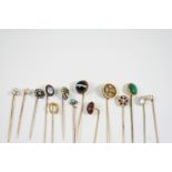 FOURTEEN ASSORTED GOLD AND GEM SET STICK PINS including one set with a circular banded agate