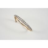 A VICTORIAN DIAMOND AND GOLD HALF HINGED BANGLE set to one side with graduated old brilliant-cut