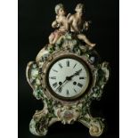 A MEISSEN STYLE PORCELAIN CLOCK probably late 19th Century with enamel dial on a brass movement, the