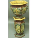 A DOULTON LAMBETH MAJOLICA STYLE JARDINIERE AND STAND of hexagonal form, moulded with scenes of