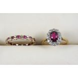 A RUBY AND DIAMOND CLUSTER RING the oval-shaped ruby is set within a surround of eight-cut diamonds,