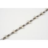 A DIAMOND AND NATURAL PEARL BRACELET the eight circular-cut diamonds in collet settings and