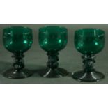 A SET OF EIGHT 'BRISTOL GREEN' ROEMER STYLE WINE GLASSES with hollow stems, raspberry prunts and
