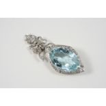 AN AQUAMARINE AND DIAMOND PENDANT the oval-shaped aquamarine is set within a floral platinum