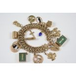 A 9CT. GOLD DOUBLE ROW CURB LINK BRACELET with engraved and plain links and suspending various