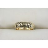 A VICTORIAN GOLD BAND with engraved foliate decoration. Size Q.