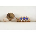 A 15CT. GOLD, LAPIS LAZULI AND PEARL RING centred with three circular lapis lazuli cabochons