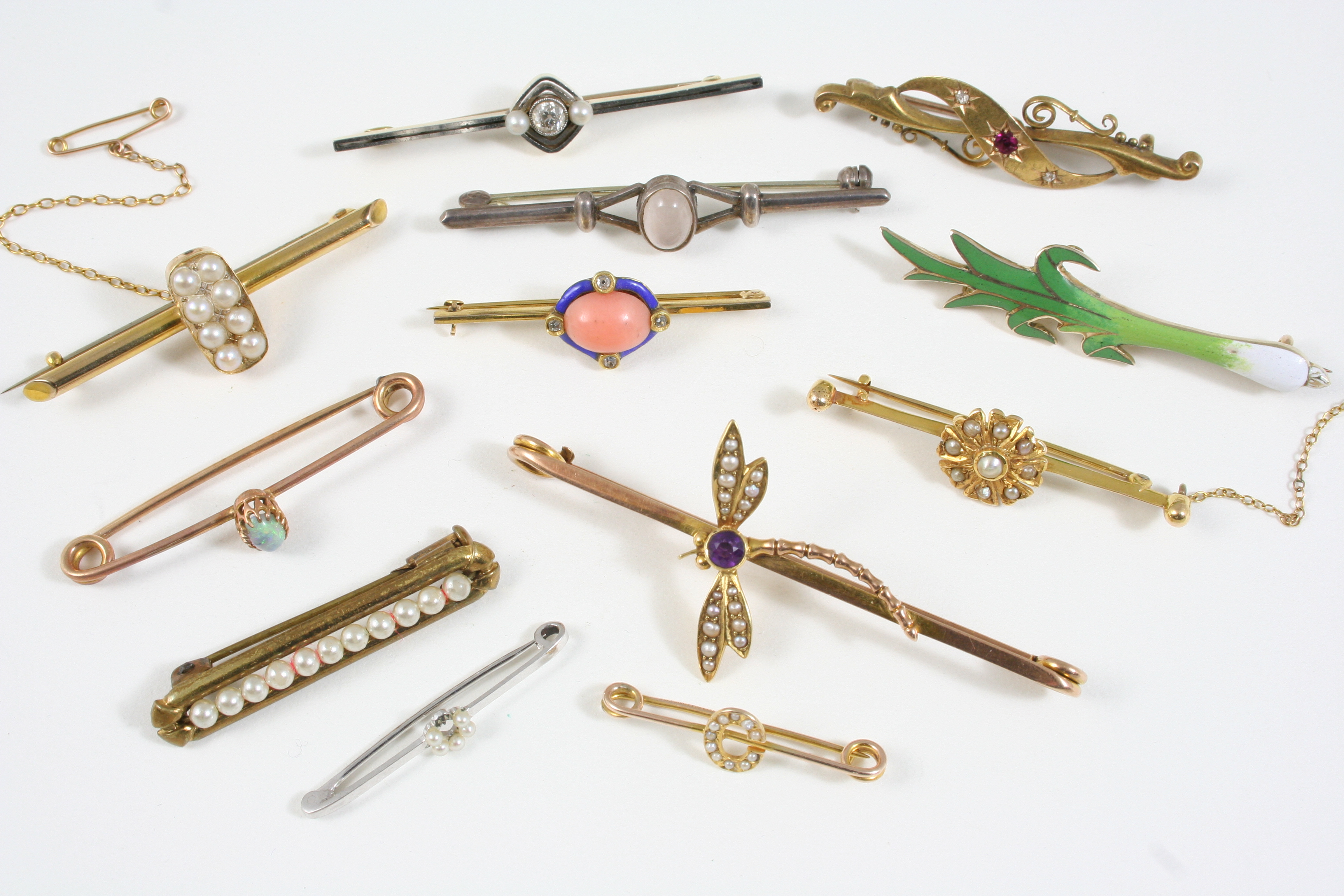 TWELVE ASSORTED GOLD AND GEM SET BROOCHES including one formed as a dragonfly and set with an