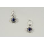 A PAIR OF SAPPHIRE AND DIAMOND CLUSTER EARRINGS BY TIFFANY & CO. each set with a circular-cut