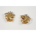 A PAIR OF DIAMOND AND GOLD EAR CLIPS BY VAN CLEEF & ARPELS of floral form, each set with circular-