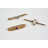 AN AMETHYST AND GOLD BROOCH the openwork design is centred with a circular-cut amethyst, 4cm.