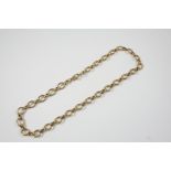 A 9CT. GOLD NECKLET formed with oval-shaped links, 41cm. long, 33 grams.