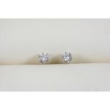 A PAIR OF DIAMOND STUD EARRINGS each set with a brilliant-cut diamond, in 18ct. white gold.