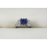 A SAPPHIRE AND DIAMOND RING the cushion-shaped sapphire weighs 4.40 carats and is set with seven