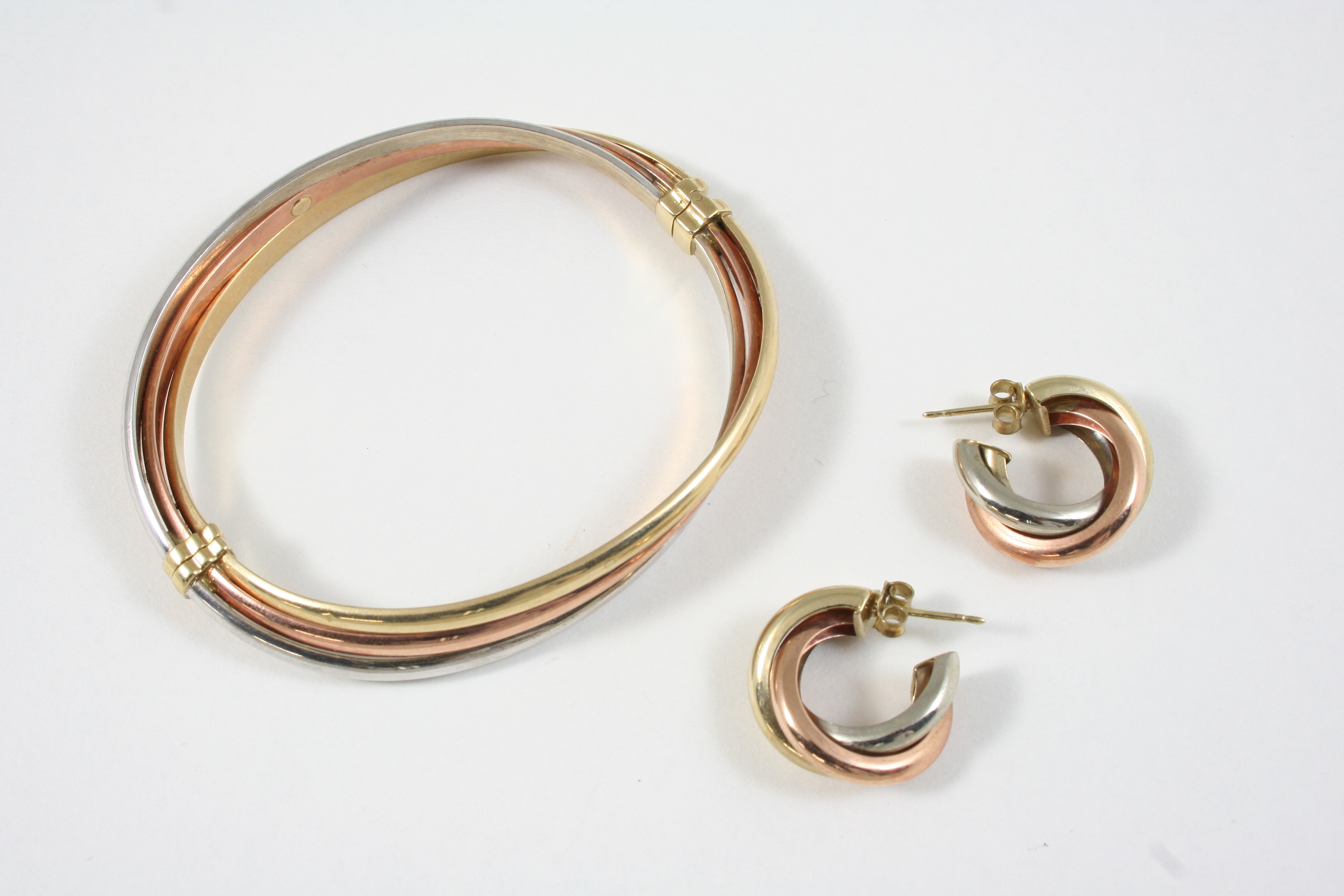 A 9CT. THREE COLOUR GOLD HALF HINGED BANGLE 11 grams, together with a pair of 9ct. three colour gold