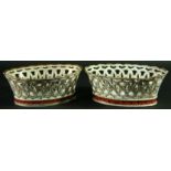 A PAIR OF PARIS PORCELAIN BASKETS mid-19th Century with pierced decoration above a painted band of