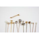 TWELVE ASSORTED GOLD AND GEM SET STICK PINS one formed as a dove and set with small pearls, one