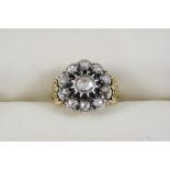 AN EARLY VICTORIAN DIAMOND CLUSTER RING the flower head is centred with a rose-cut diamond, within a