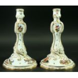 A PAIR OF DRESDEN PORCELAIN CANDLESTICKS decorated with scenes of birds between scrolling gilt