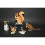 HUTSCHENREUTHER SQUIRREL a porcelain figure of a squirrel holding an acorn, also with a