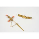 A CORAL AND GOLD JABOT PIN in the form of a dagger, with cannetille decoration and with coral