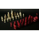 A CHINESE RED AND WHITE IVORY PART CHESS SET King 4 1/4ins. (11cms.) high.