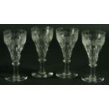 A SET OF SIX WINE GLASSES with engraved fruiting vine decoration above faceting. Together with