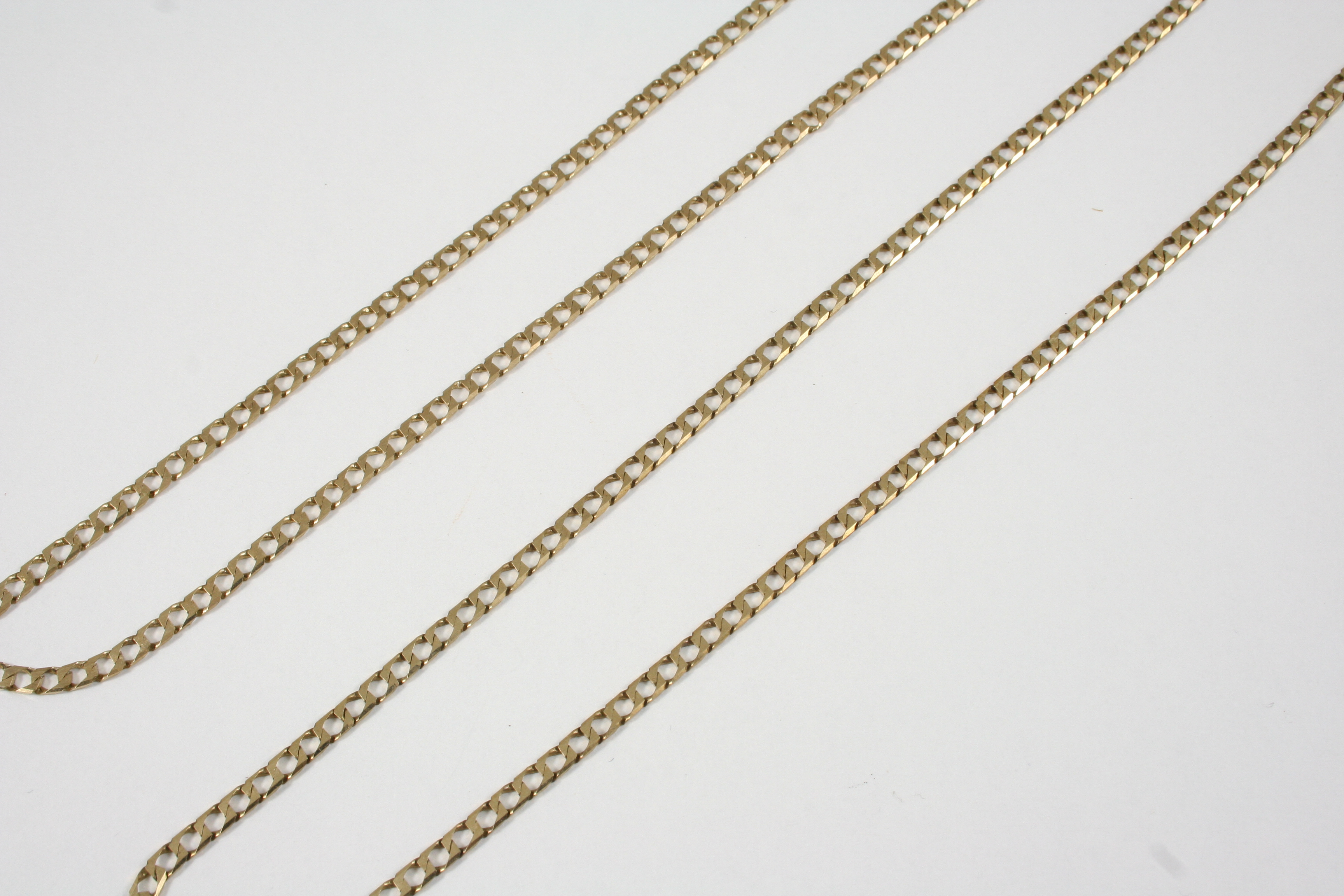 A 9CT. GOLD FLAT CURB LINK NECKLACE 75cm. long, 9.3 grams, together with another 9ct. gold flat curb