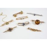 EIGHT ASSORTED GOLD AND GEM SET BROOCHES including a white gold one set with two circular-cut