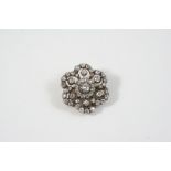 A VICTORIAN DIAMOND CLUSTER BROOCH of flower head form, set with graduated old brilliant-cut