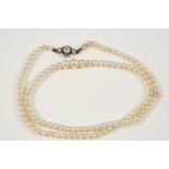 A SINGLE GRADUATED NATURAL PEARL NECKLACE the pearls graduated from 2.8mm. to 5.0mm. to a diamond