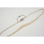 A SINGLE ROW NATURAL PEARL NECKLACE the graduated pearls are set to a diamond set clasp, 45cm. long.